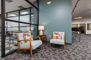 Lounge seating in a large open room with a variety of comfortable chairs.