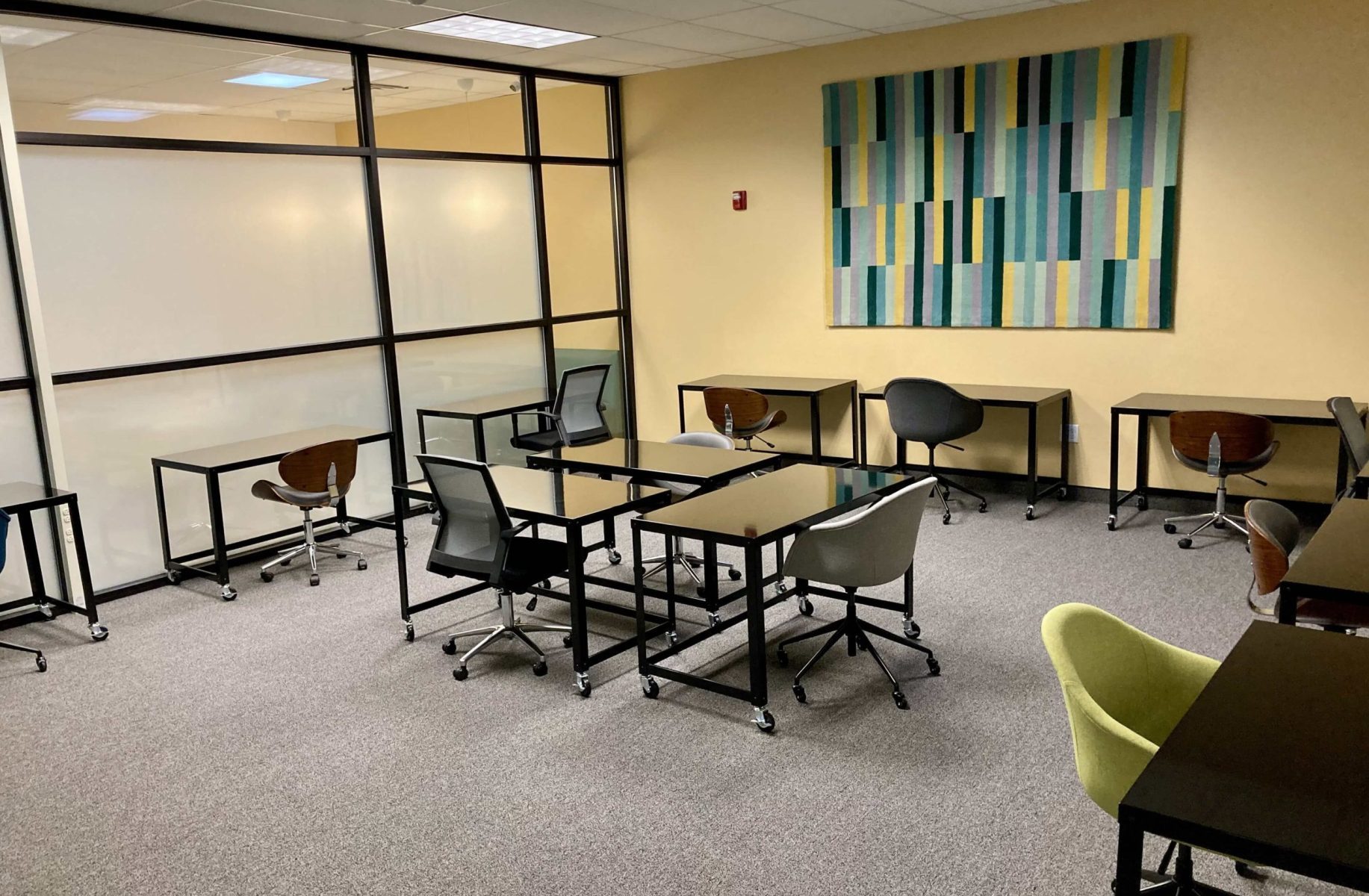 The Quiet Room has many wooden tables and chairs in a large, open space.