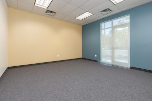 Team Room shows a large open space with one cream wall, one teal wall, and large windows.