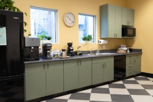 onflume's kitchen with yellow walls and green cabinets