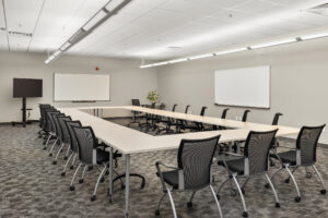 classroom with O shaped table and white board at the front