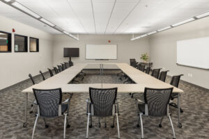 classroom with O shaped table and white board at the front