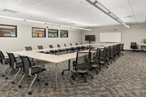 classroom with O shaped table and white board at the front